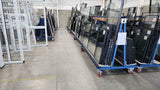 Photo shows A Frame Stillage units being used to store and transport double glazing units and window frames.