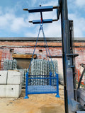 Photo of metal pallet cage being lifted by forklift crane