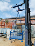 Photo of pallet cage being lifted by forklift crane