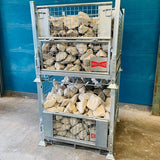 Stackable pallet cages loaded with quarry stone